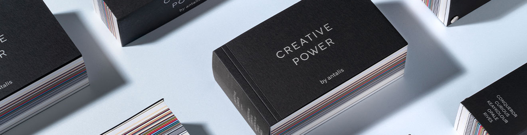 Plusieurs boîtes d’échantillons Olin, disposées sur un fond vert menthe, présentées de manière moderne.